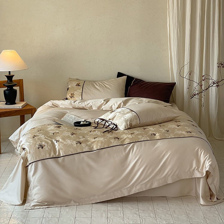 Satin bedding set in jacquard look with floral embroidery details and ribbon ties