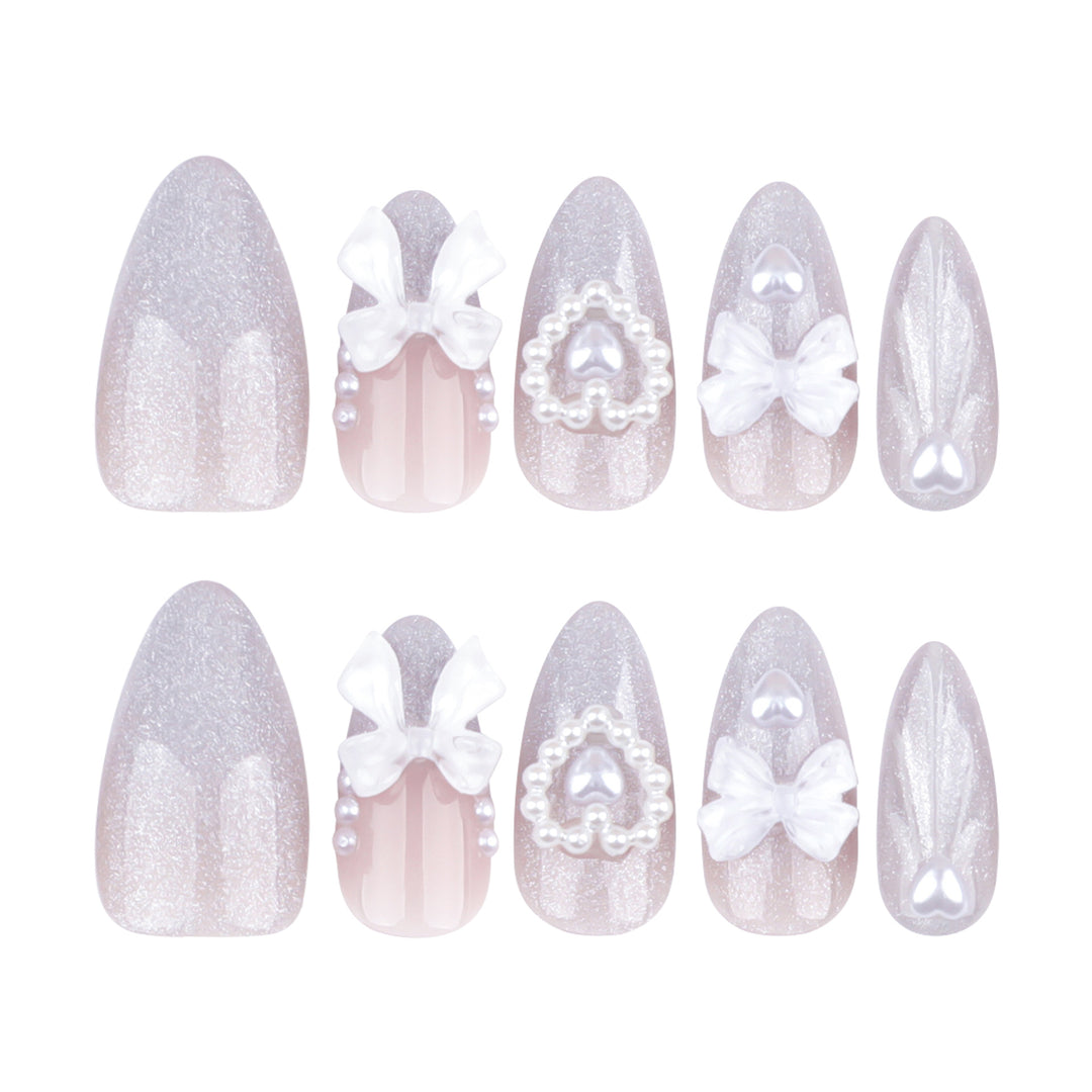 Artful nail decoration with pearl and bow accents Kalsten