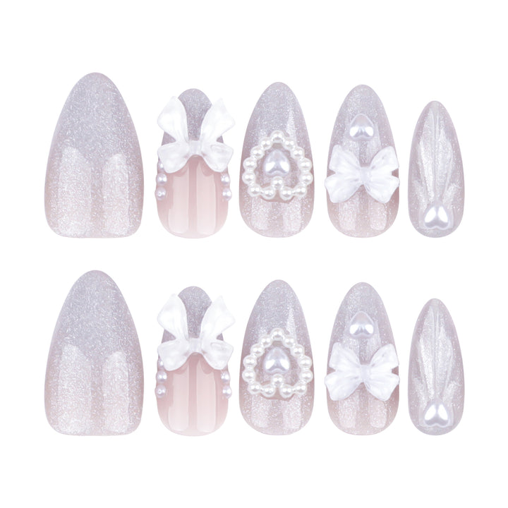 Artful nail decoration with pearl and bow accents Kalsten