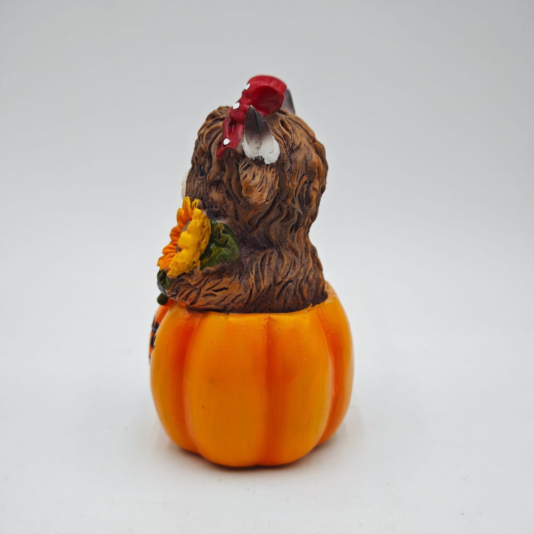Funny decorative figure of a Highland cow in pumpkin costume Kalsten