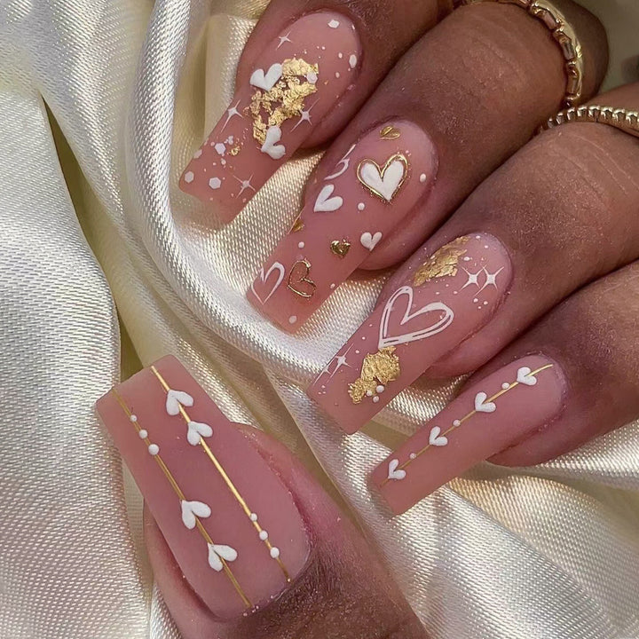 Artificial nail art with heart and glitter designs Kalsten