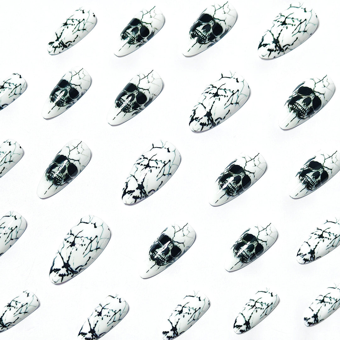 Artificial nails with playful skull design and crackle effects Kalsten