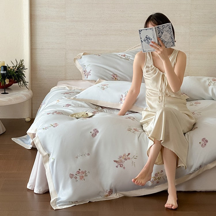 Fine satin duvet cover set with delicate floral embroidery and elegant piping