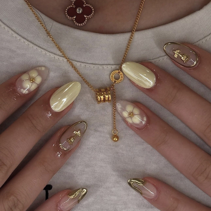 Artful nail art with floral decorations and glitter accents Kalsten