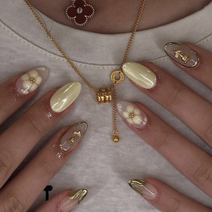 Artful nail art with floral decorations and glitter accents Kalsten