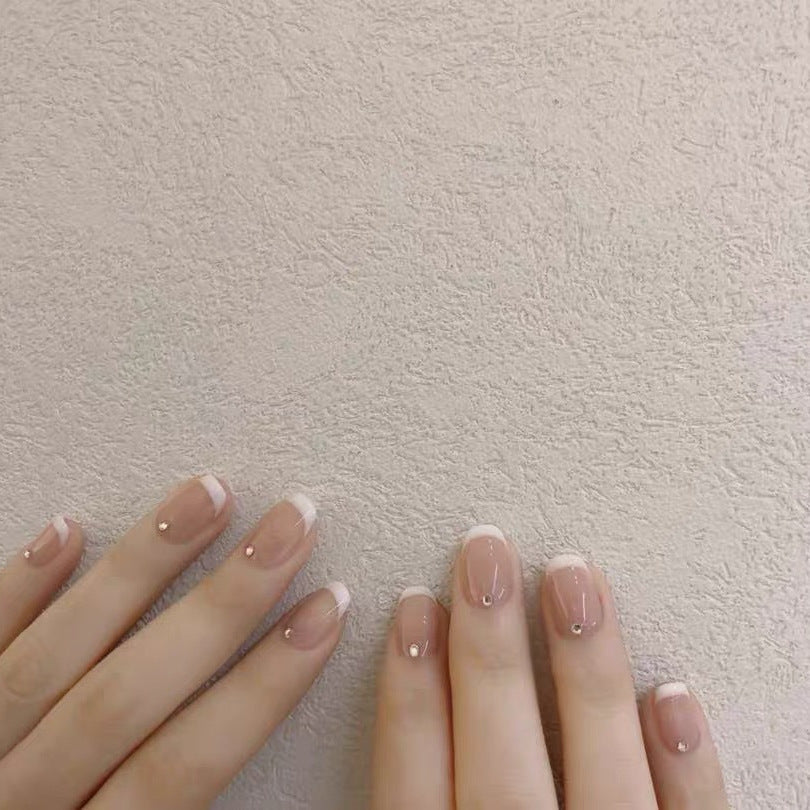 Artificial nails with elegant French tip and rhinestone accents Kalsten