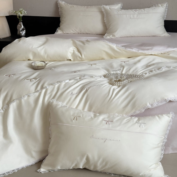 Elegant bedding set made of silky fine satin with embroidered bows and lace trim