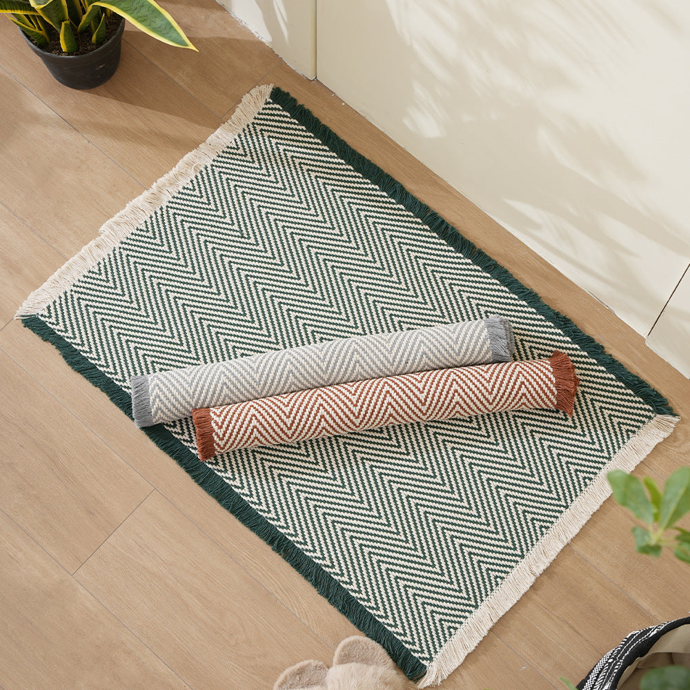 Handwoven cotton bath mat with herringbone pattern and fringes Kalsten