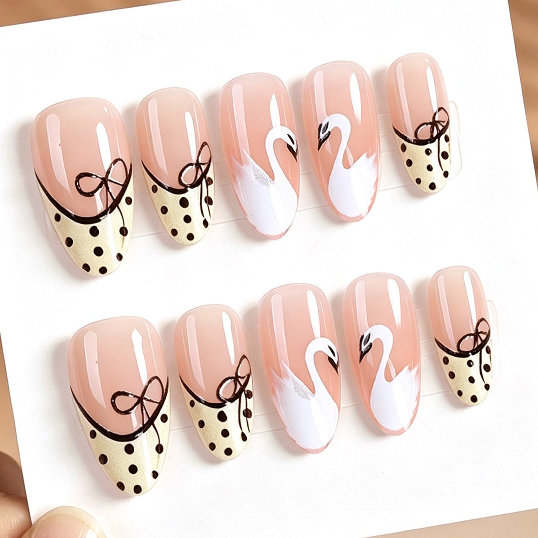 Artificial nails with elegant swans and playful bow motifs Kalsten