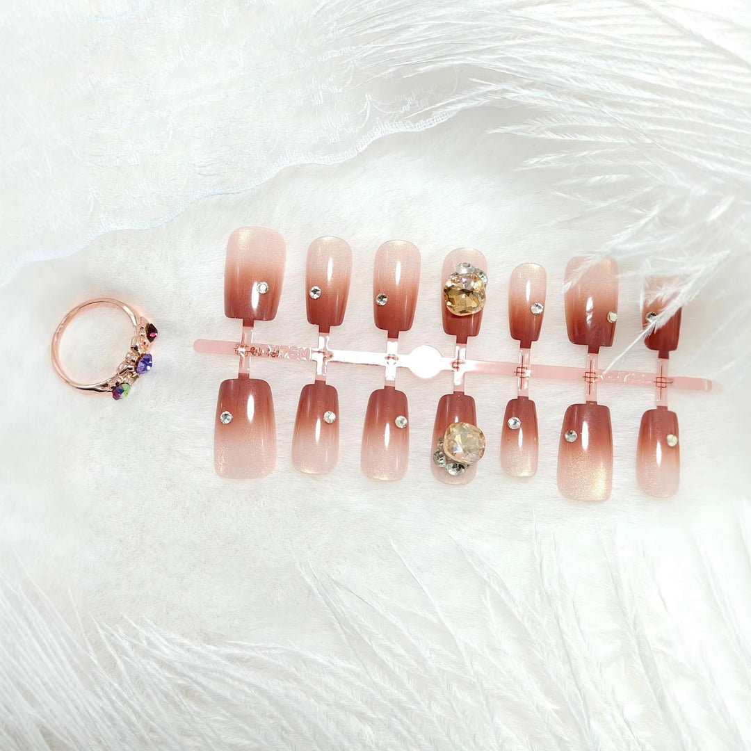Artificials nails in elegant ombre style with rhinestone embellished applications Kalsten