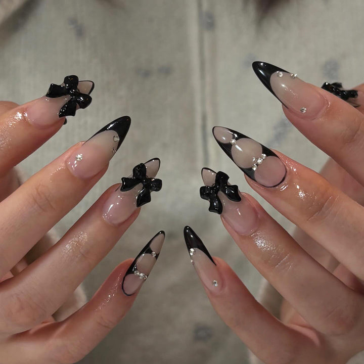 Acrylic nail set with shimmering accents and elegant bows Kalsten
