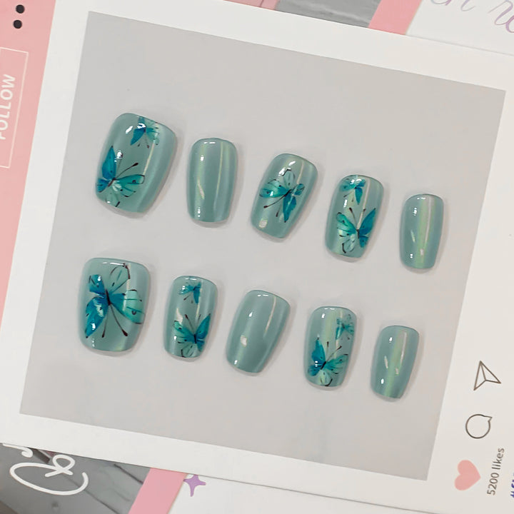Artistic acrylic nails with butterfly motif Kalsten