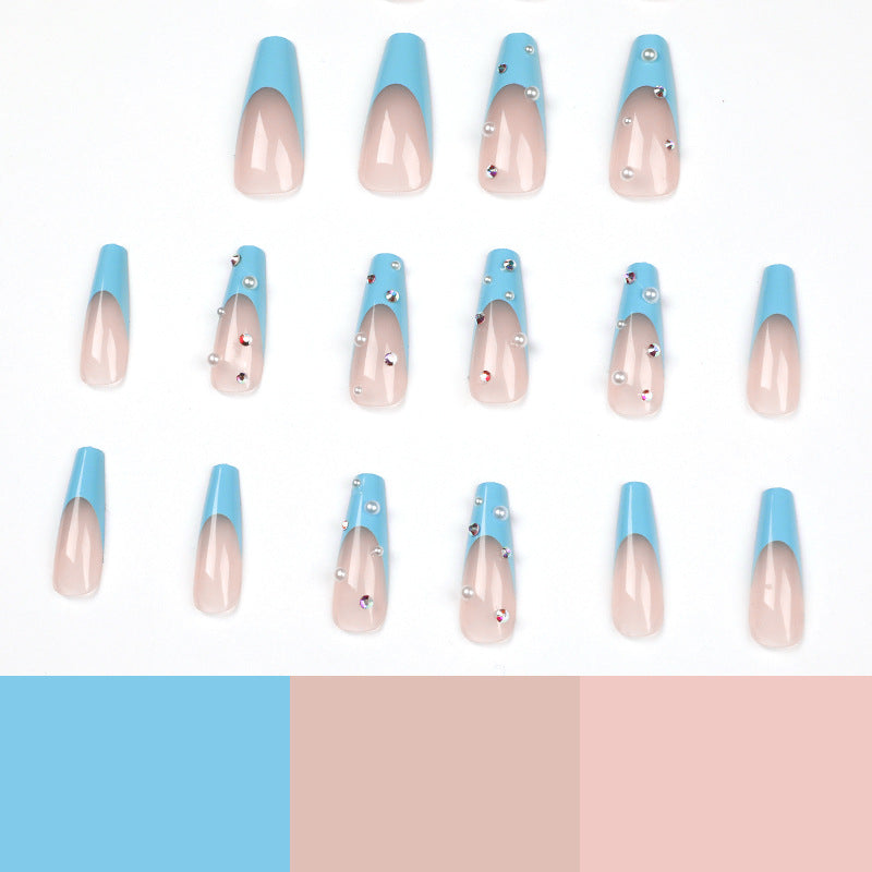 Artificial nail extensions with glitter and pearl accents Kalsten