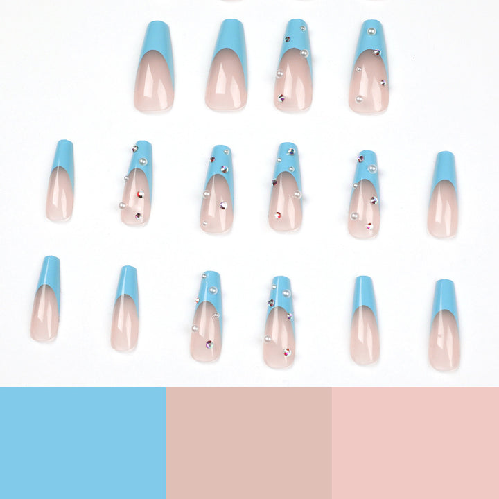 Artificial nail extensions with glitter and pearl accents Kalsten