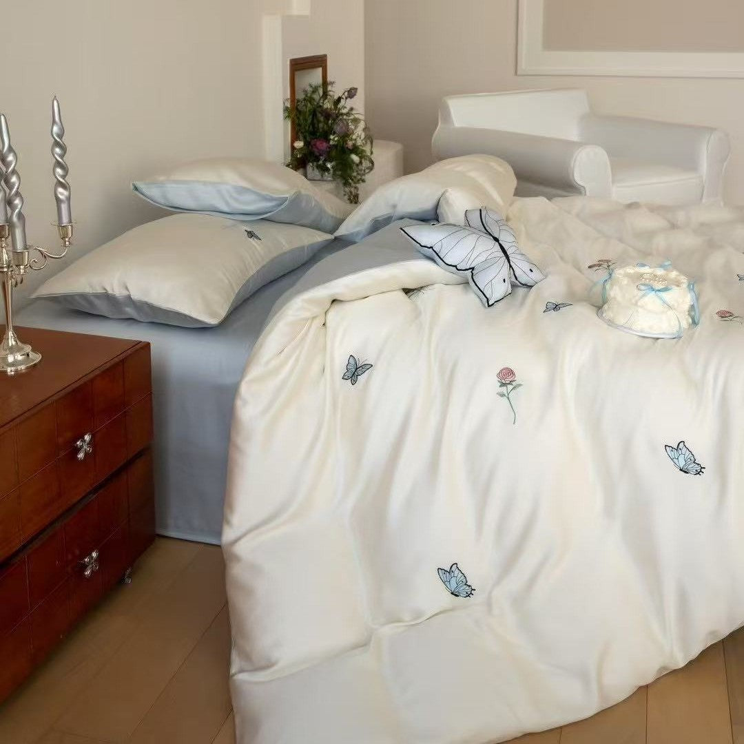 Luxurious satin bedding set with embroidered cherry motifs, reversible function and plush bunny pillow