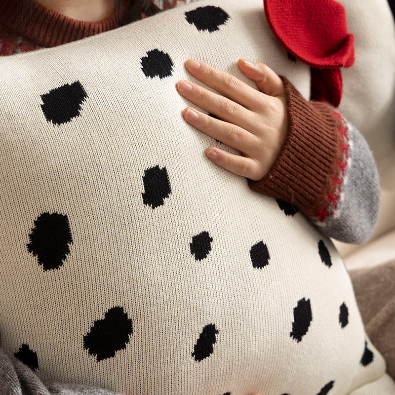 Decorative knitted cuddle pillow in the shape of a dog with a quilted body and bow detail Kalsten