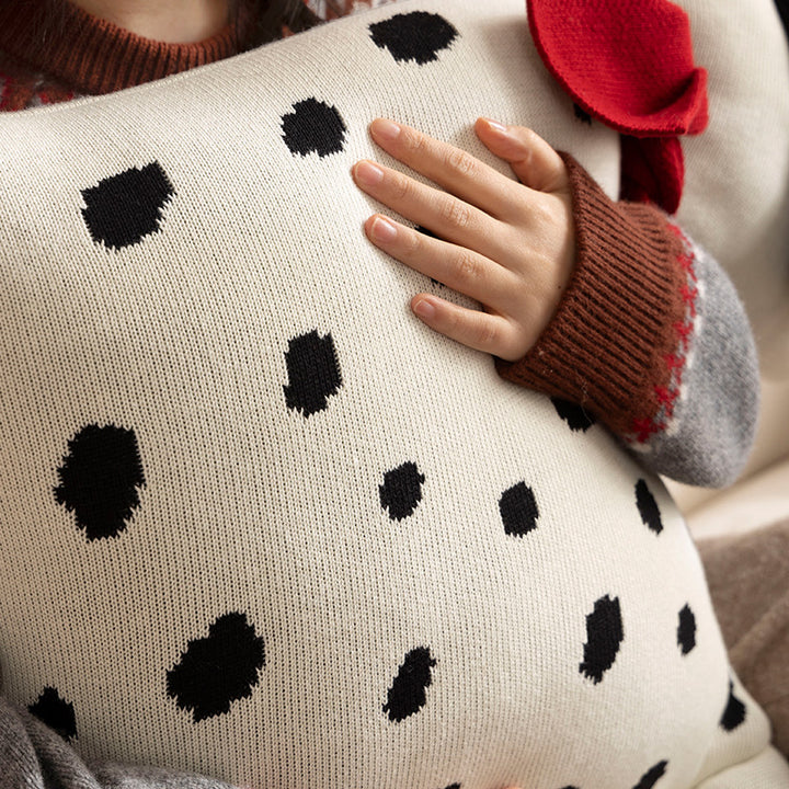 Decorative knitted cuddle pillow in the shape of a dog with a quilted body and bow detail Kalsten