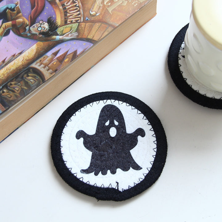 Round felt and cotton coasters with embroidered Halloween haunted house motif