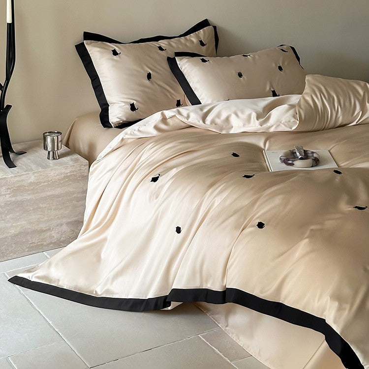 Luxurious satin bedding set with cherry embroidery and contrasting trim
