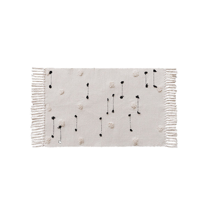 Hand-tufted bathroom mat with fringes, decorative dot-and-dash pattern and non-slip backing Kalsten