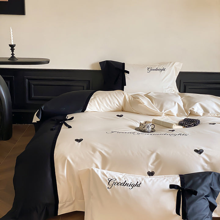 Reversible satin bedding set with bow appliqué and embroidered lettering
