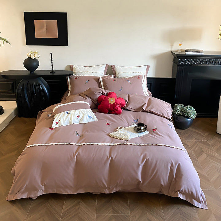 Duvet cover set made of premium cotton satin with subtly embroidered wildflower motif and ruffle edge