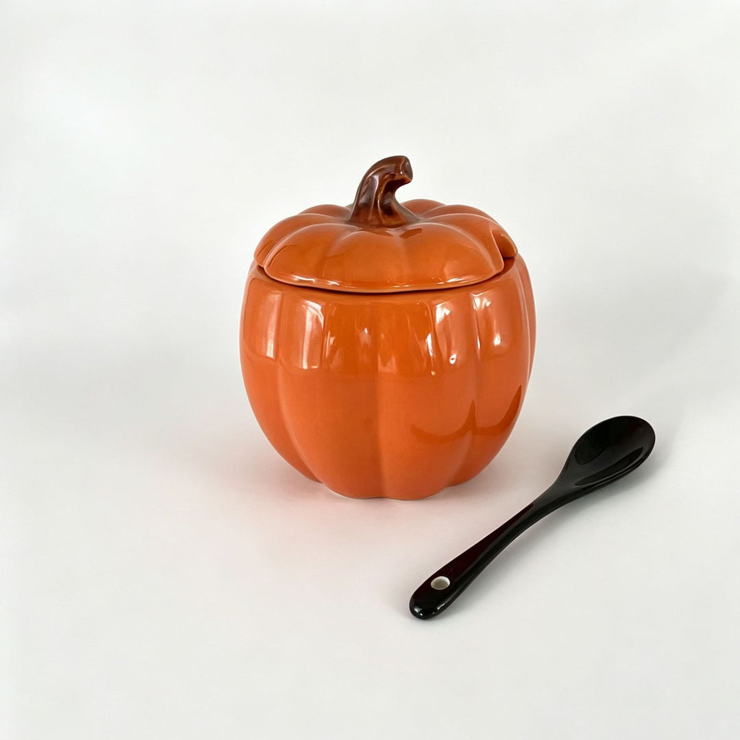 Ceramic storage jar in pumpkin shape with lid and spoon