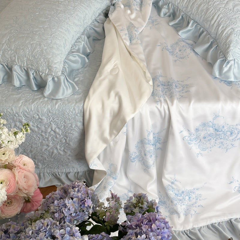 Quilted bedspread with ruffle and reversible satin bedding set