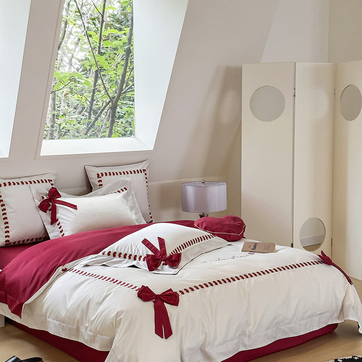 Reversible cotton satin bedding set with decorative bow appliqués