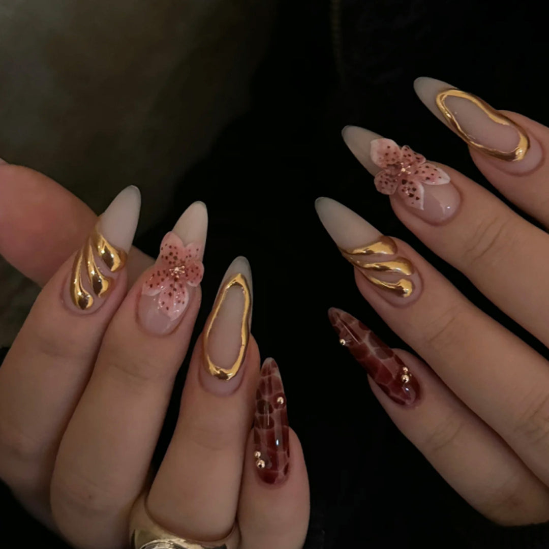 Artful stiletto nails with elegant floral designs and glitter accents Kalsten