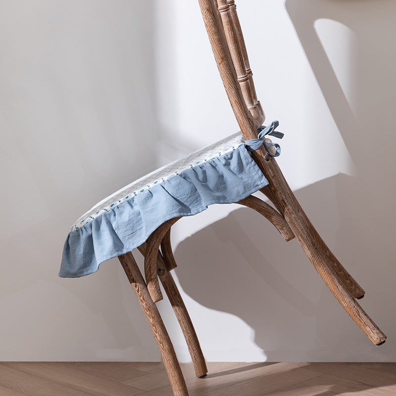 Padded chair cushion with ties, ruffled edge and embroidered hole pattern look Kalsten