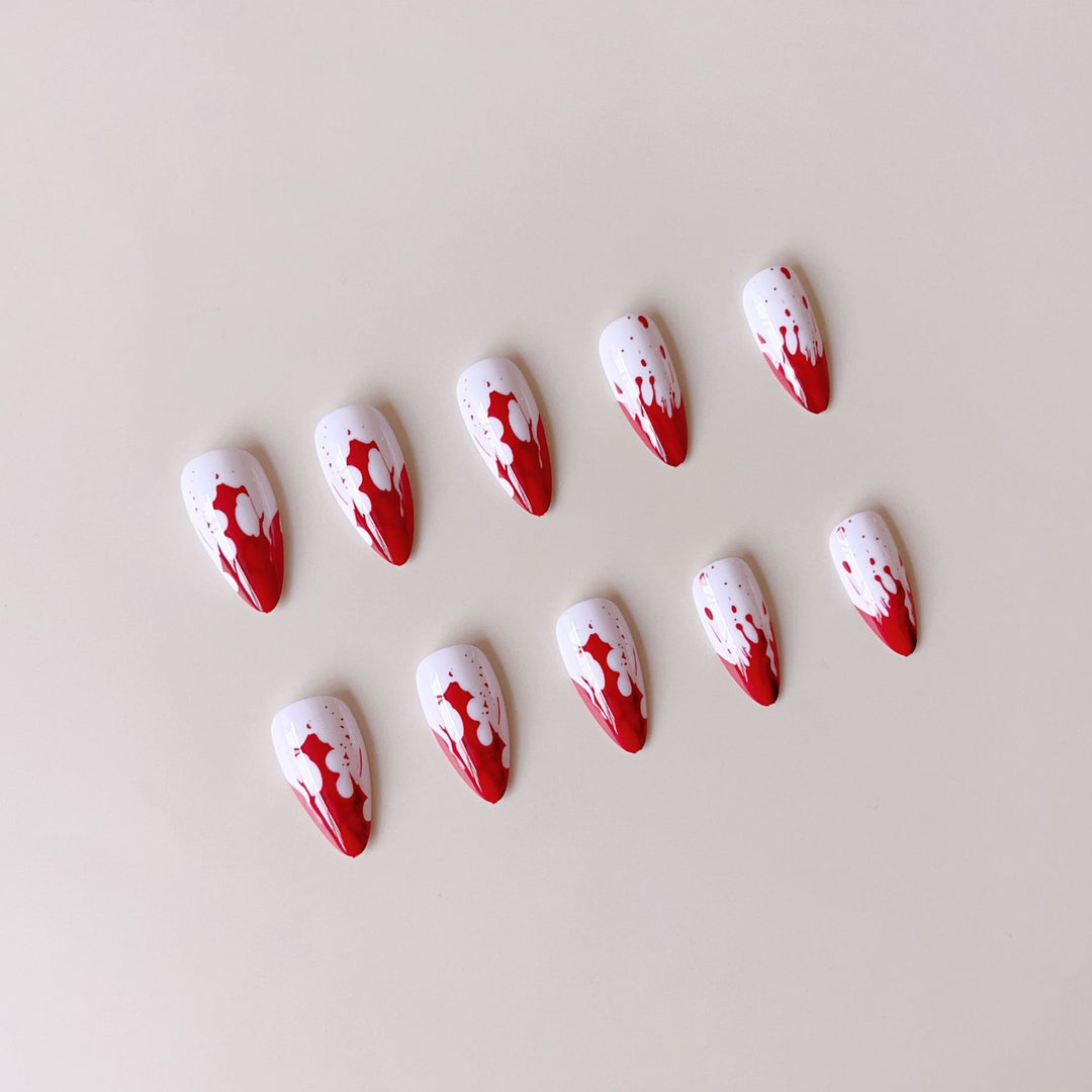 Artificial nail set with blood red inspired design and pointed accents Kalsten