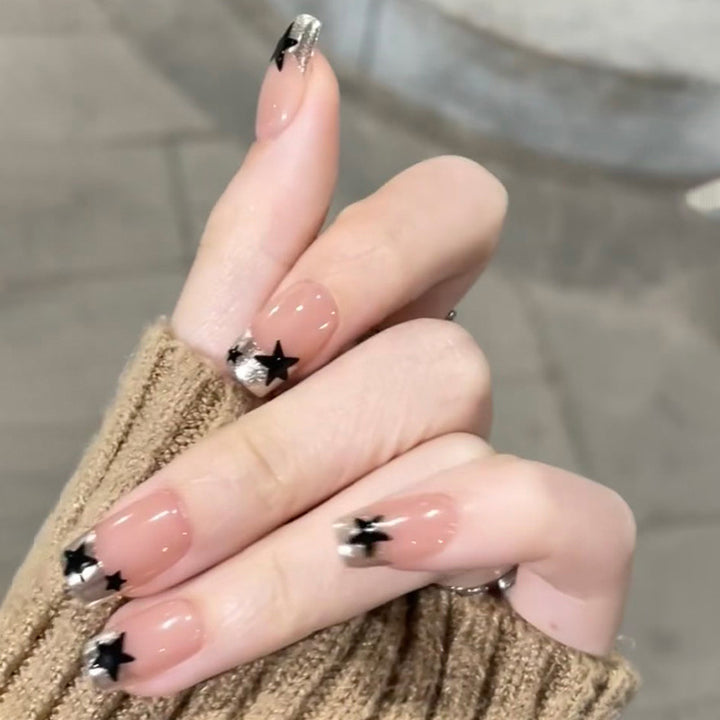 Sparkling nail art with stars and glitter accents Kalsten