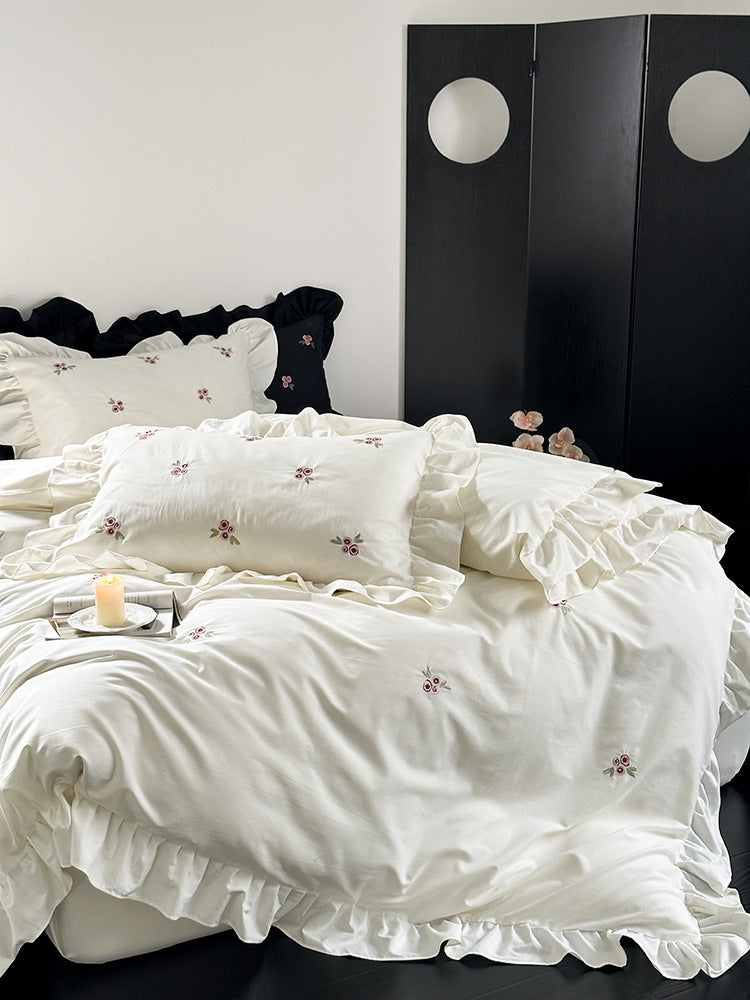 Elegant bed linen set made of breathable cotton satin with delicate floral embroidery and ruffled hem