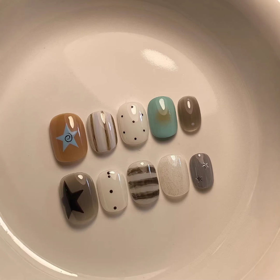 Artistic Press-On Nail Set with Abstract Patterns and Decorative Elements
