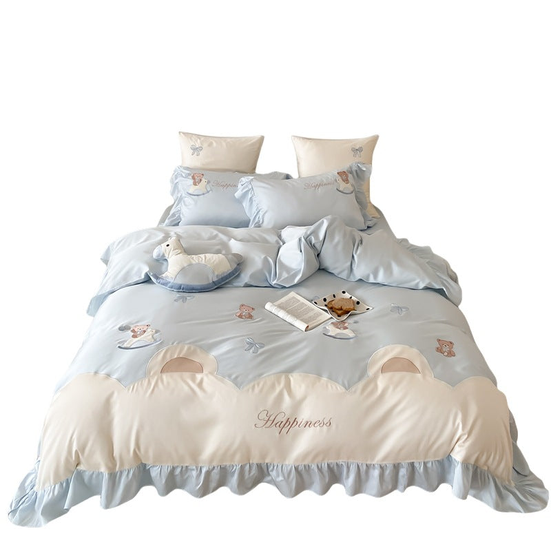 Playful satin bedding set with ruffled border, appliqués and quilted head section