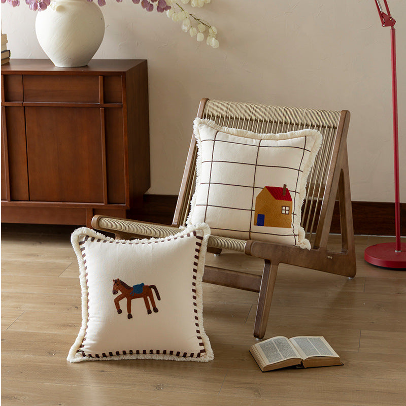 Decorative cushion cover made of cotton blend with fringes, check pattern and embroidered house Kalsten