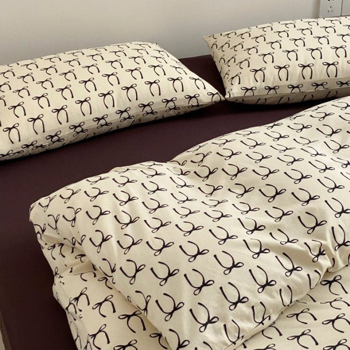 Light cotton bedding set with quilted topper and fine stripe pattern