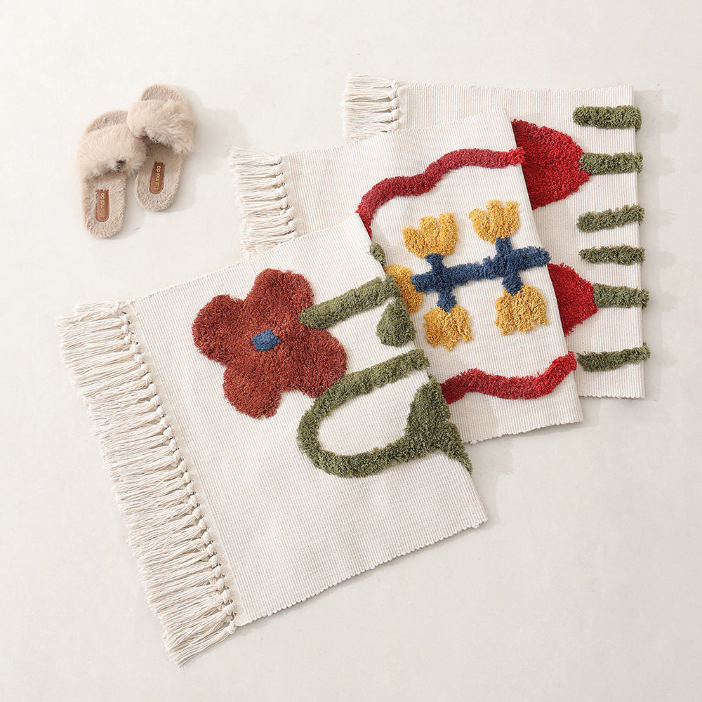 Handwoven cotton bath mat rug with tufted flower appliqué and tassels Kalsten