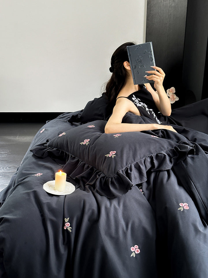 Elegant bed linen set made of breathable cotton satin with delicate floral embroidery and ruffled hem