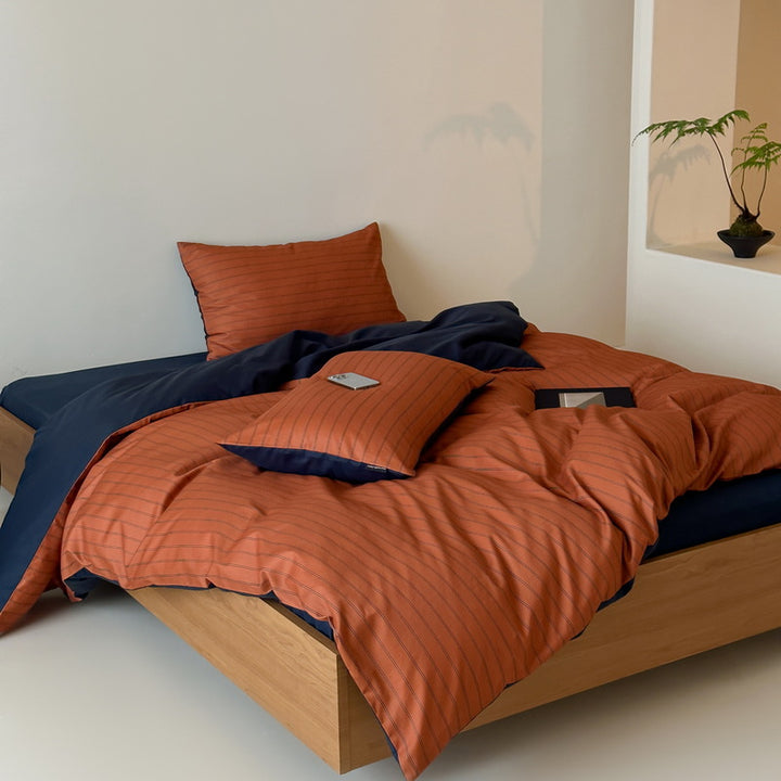 Reversible cotton satin bedding set with fine striped pattern and contrasting backside