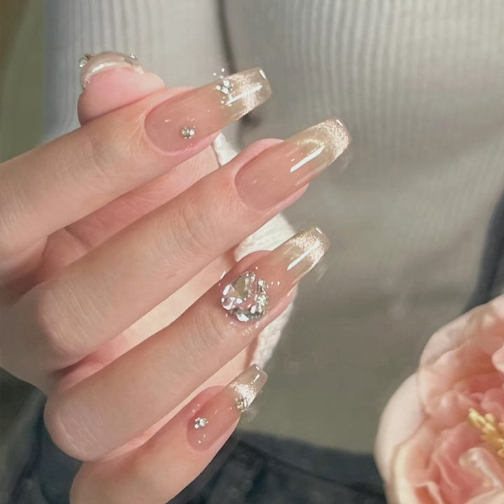 Acrylic nail set with glamorous glitter accents and elegant jewelry embellishments Kalsten