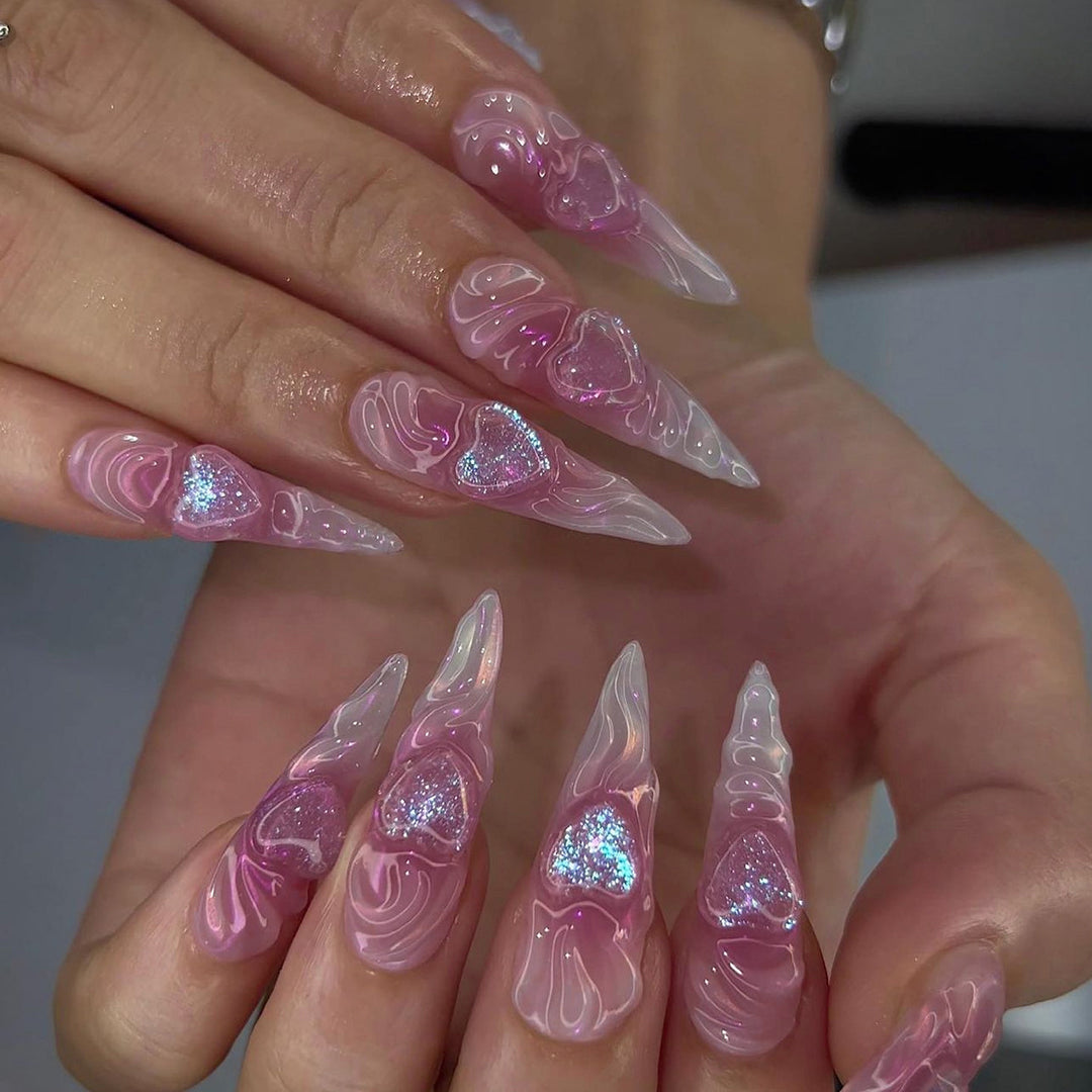 Artistic stiletto nails with heart design and glitter accents Kalsten