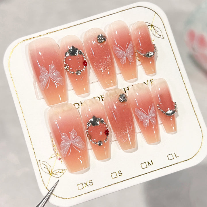 Artificial nail extensions with floral design and sparkling accents Kalsten