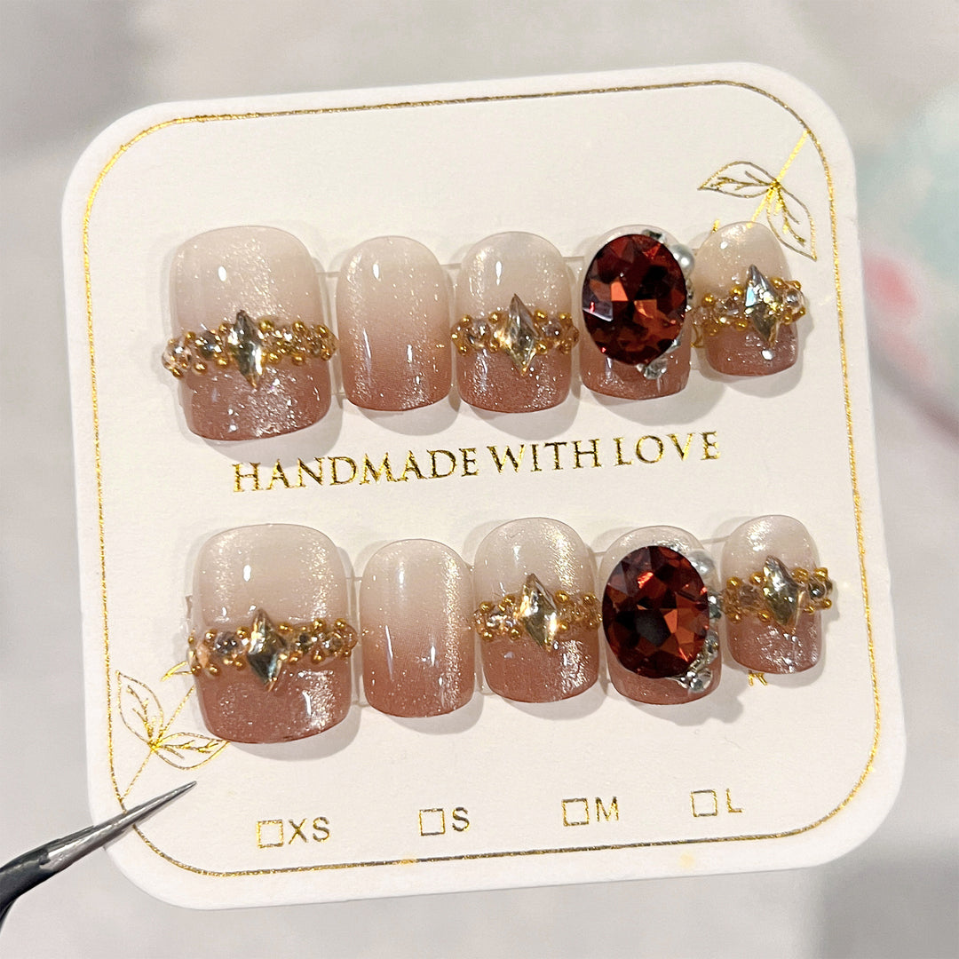 Artificial nail art with glitter and jewelry embellishments Kalsten
