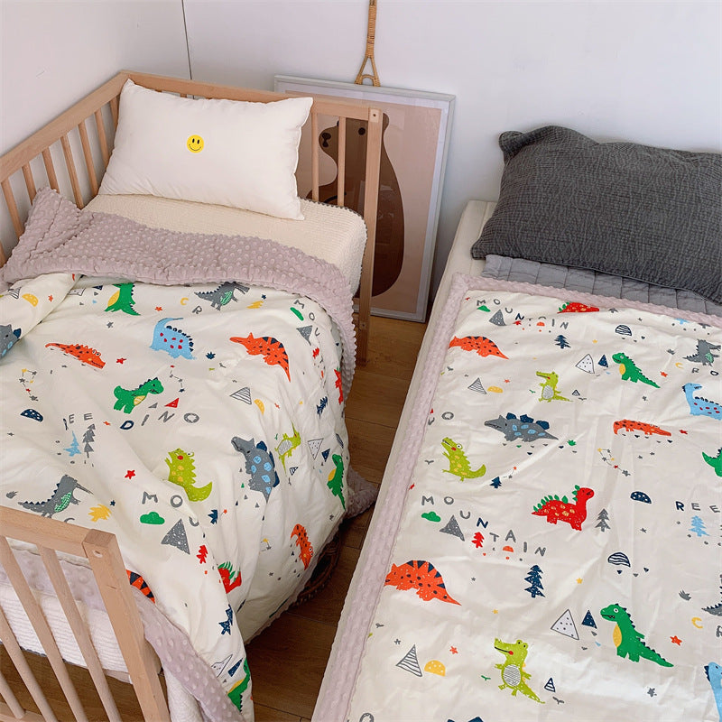 Children's quilt with colorful dinosaur print and soft minky border