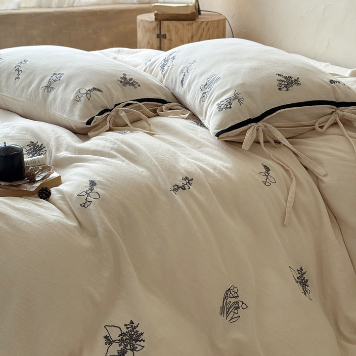 Breathable cotton-linen bedding set with delicate floral embroidery and bow closure