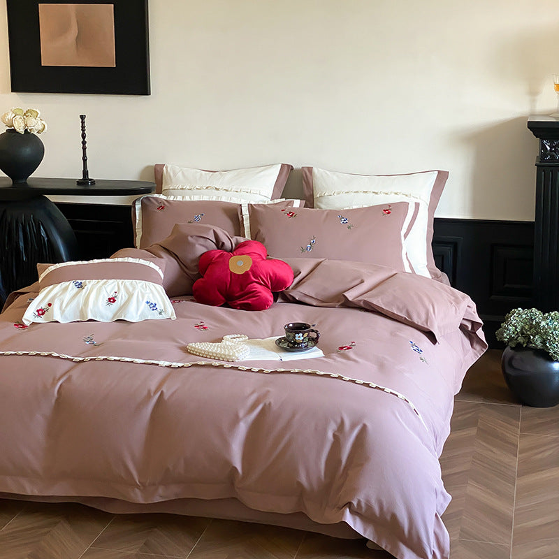 Duvet cover set made of premium cotton satin with subtly embroidered wildflower motif and ruffle edge