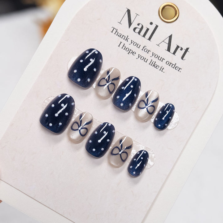 Decorative Nail Art with Bow and Polka Dot Design