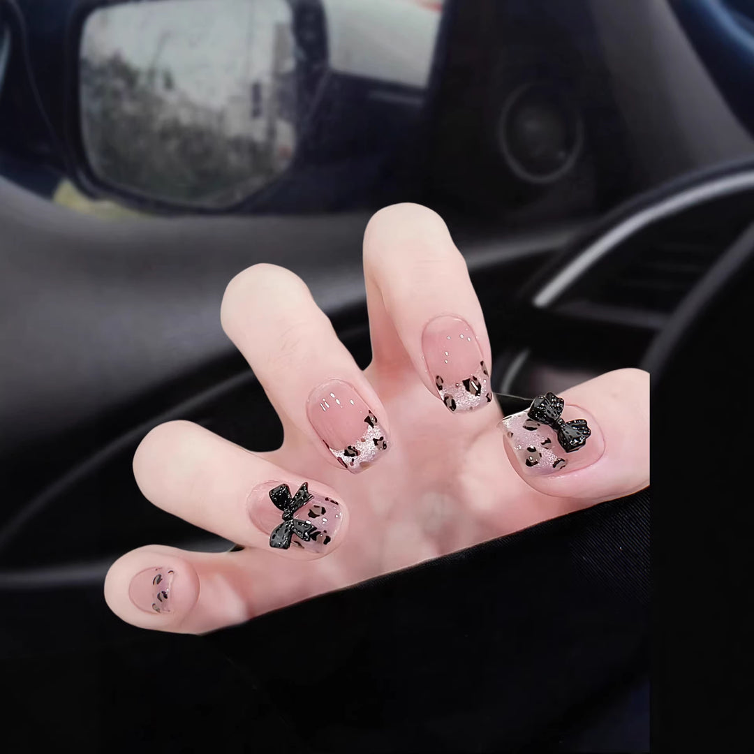Artistic Press-On Nail Set with Playful Bow and Animal Print Designs